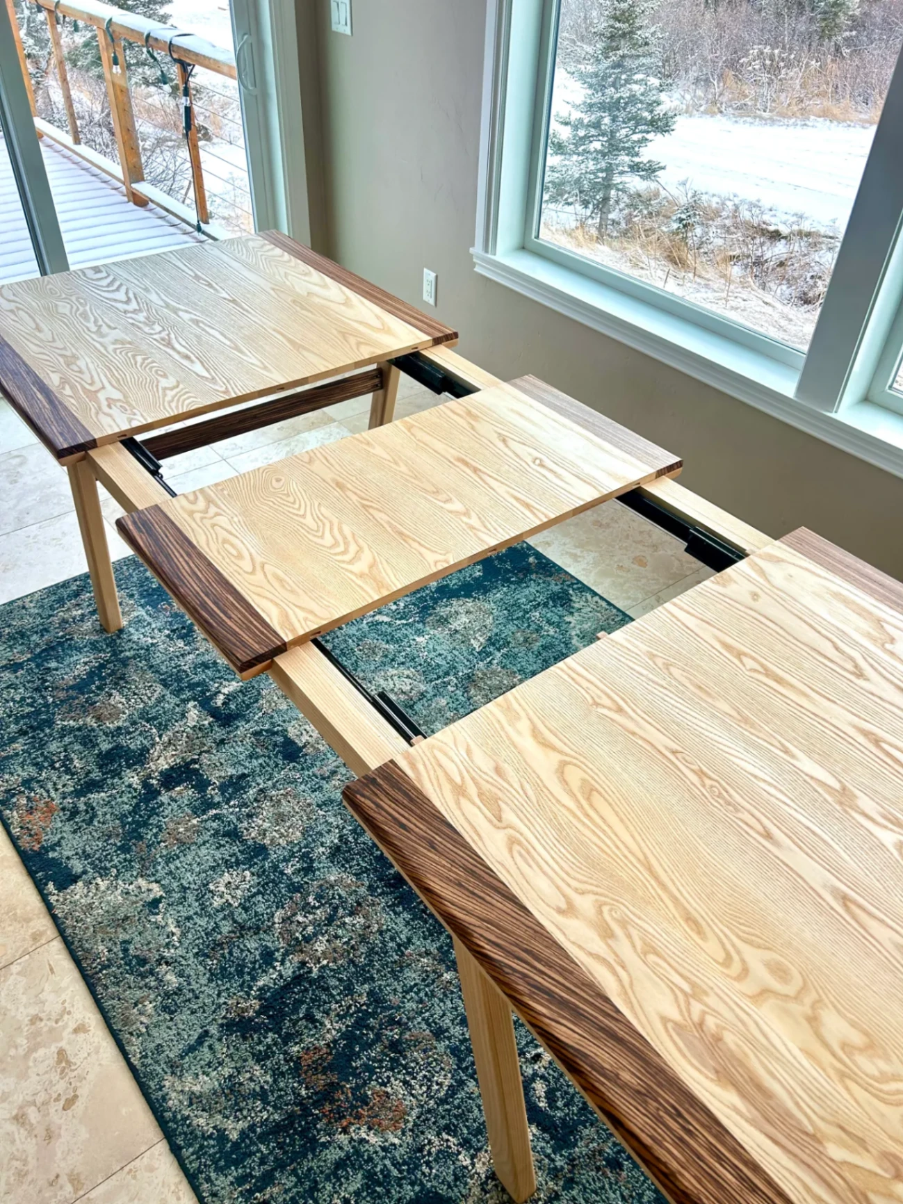 Ash and zebrawood expanding table showing hidden leaf mechanism